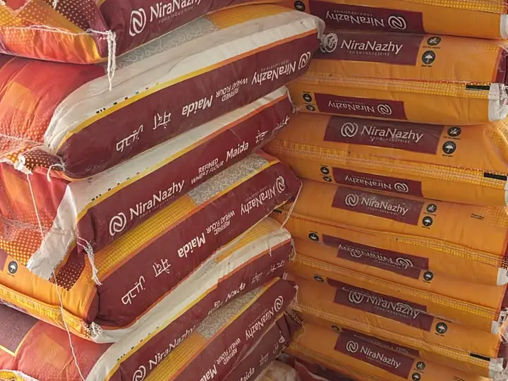 Stacked bags of NiraNazhy refined wheat flour (maida)