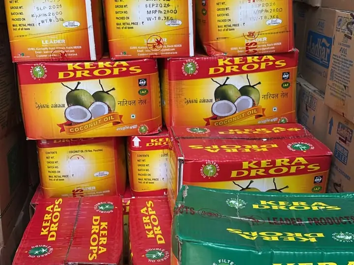 Cartons of Kera Drops coconut oil stacked high