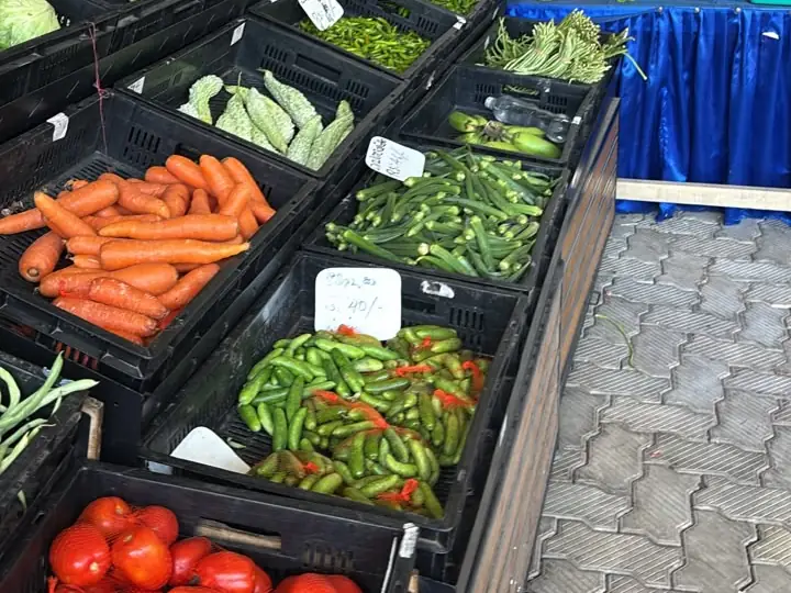 Crates of tomatoes, carrots, green chillies and beans
