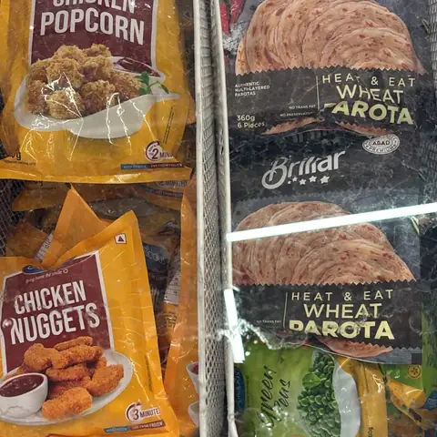Chicken popcorn and chicken nuggets packs beside Brillar wheat parotta