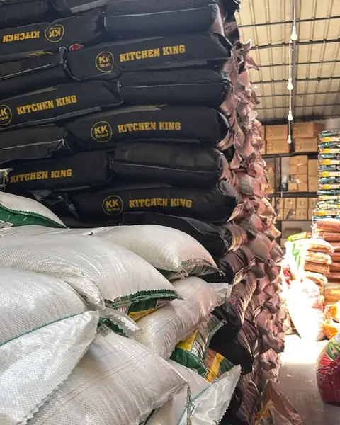 Black Kitchen King sacks stacked above white sacks in the warehouse