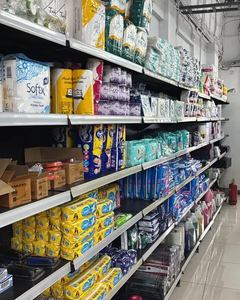 Kitchen towels, tissues, diapers and paper cups on long shelves