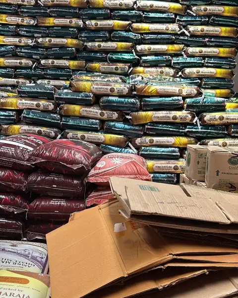 A wall of biryani rice sacks in the warehouse