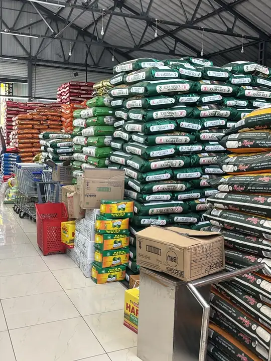 The shop floor, with rice sacks stacked high beside the shelves